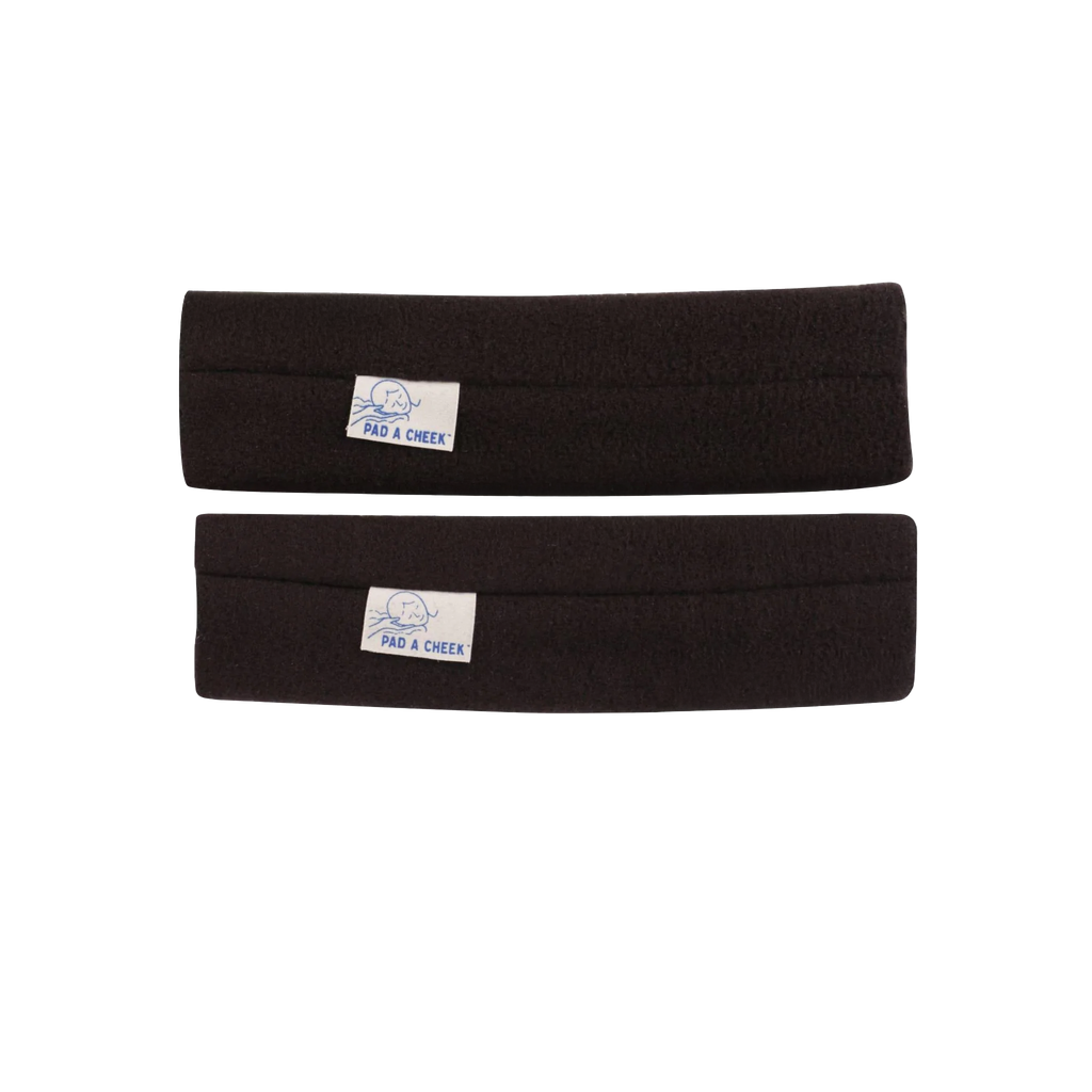 Pad A Cheek CPAP mask strap pads, black fabric pair with white brand labels on a black background.