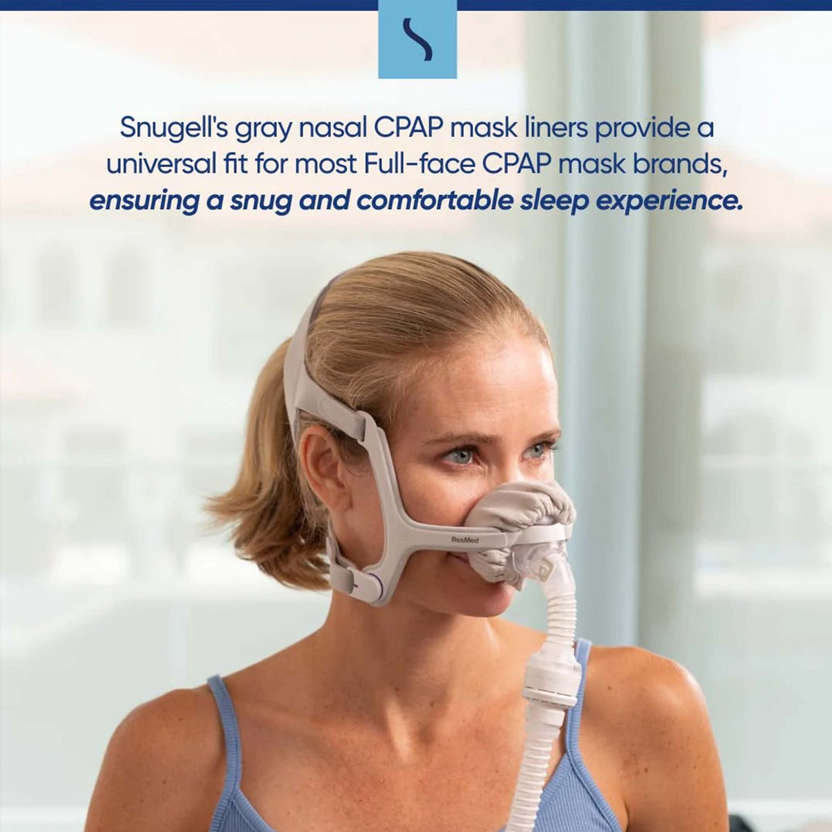 Woman wearing a CPAP mask with a gray Snugell nasal liner for a comfortable fit.