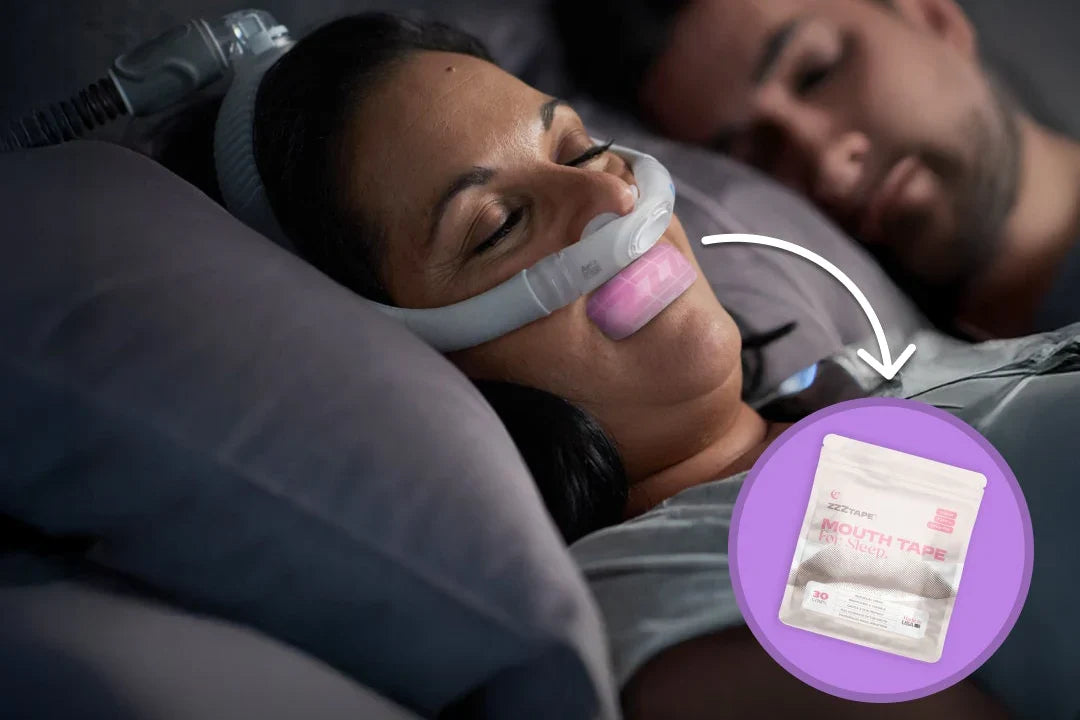 Woman sleeping with a CPAP mask and ZzzTape mouth tape applied to her lips.