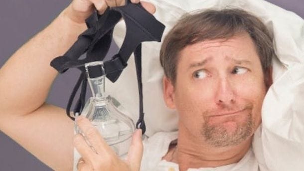 man holding full face cpap mask