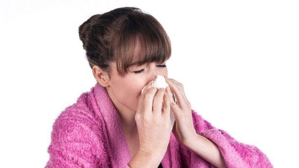 woman blowing her nose