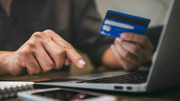 man with credit card and laptop