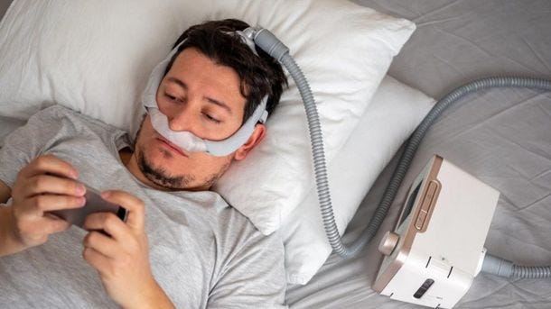 laying in bed with cpap equipment