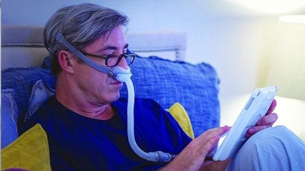 man adjusting cpap machin