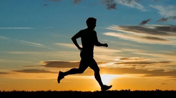 man running with sunset