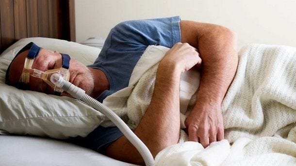 Man sleeping with resmed nasal cpap mask on side