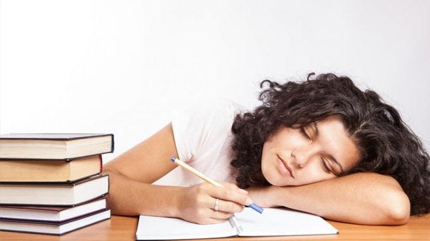 woman sleeping while studying