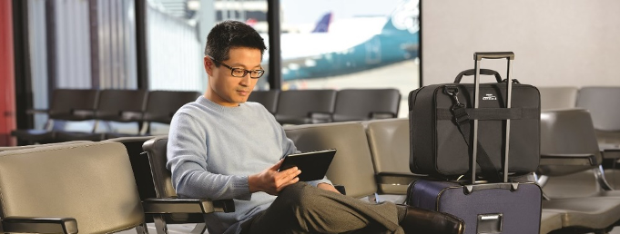 Man using tablet at airport.