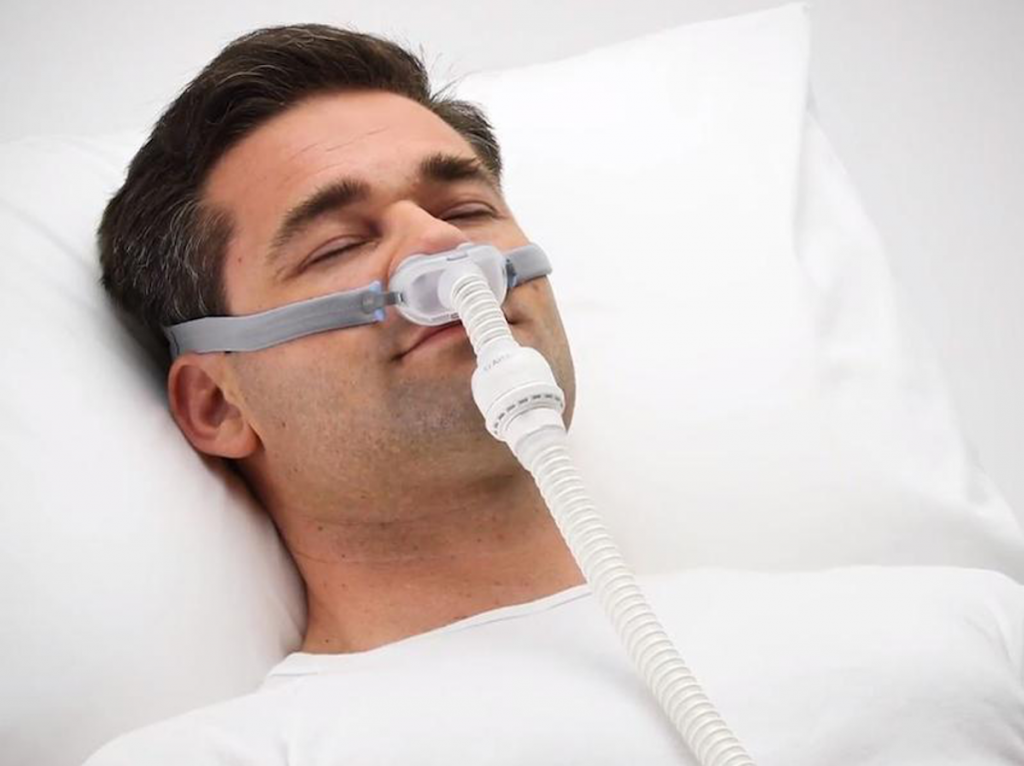 man sleeping with cpap mask