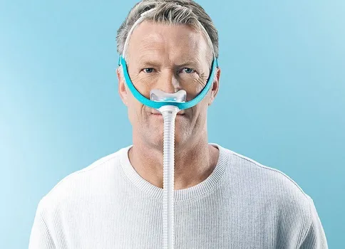 Man wearing nasal CPAP mask. 